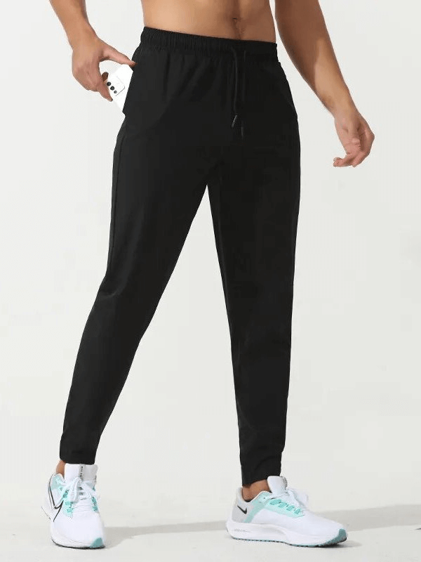 Sports quick-drying men's pants with zippered pockets, perfect for running, made of nylon and polyester, featuring elastic waist.